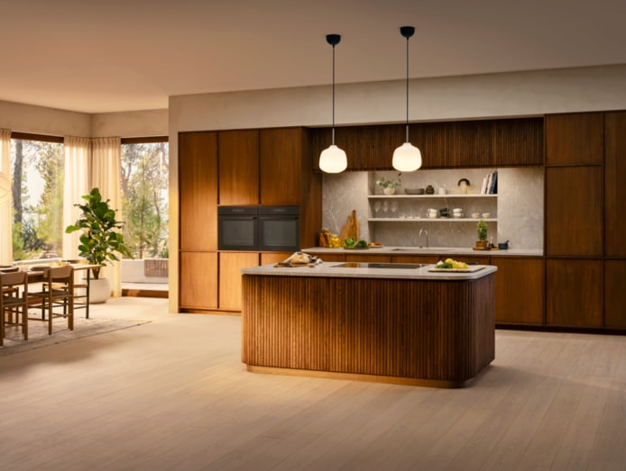  Warm kitchen with wood cabinets and built-in ovens